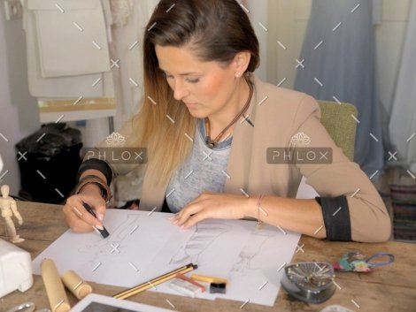 demo-attachment-557-female-dressmaker-drawing-sketches-PSVNXTC